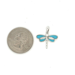 Inlaid wing dragonfly moissanite pendant in sterling silver with turquoise wings, shown beside a US quarter for scale