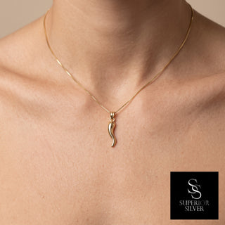 Italian Horn Cornicello 14K yellow gold pendant worn on a model