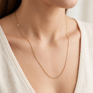 Superior Silver 20-inch solid 10K yellow gold link chain necklace worn on a model with a white top