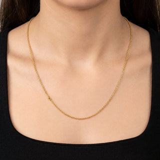 Superior Silver 22-inch delicate 10K yellow gold cable link chain worn around a woman's neck