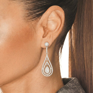 Long Open Teardrop Pavé Moissanite Drop Earrings in sterling silver, worn on model