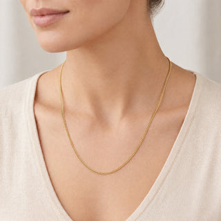 Superior Silver 18-inch micro curb link chain in solid 10K yellow gold worn on a model