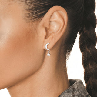 Moon and Star Drop Moissanite Stud Earrings in sterling silver, worn on model