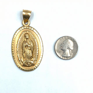Superior Silver 10K yellow gold Mother Mary oval pendant with diamond-cut detailing next to a US quarter for scale.