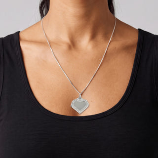 Pavé-Edged Flat Open Heart Moissanite Pendant in sterling silver, worn on model