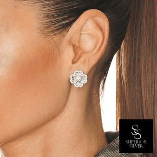 Pavé Four-Leaf Clover Heart Moissanite Stud Earrings in sterling silver, worn on model