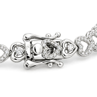 Pavé heart and solitaire heart link moissanite bracelet in sterling silver, box clasp with safety latches