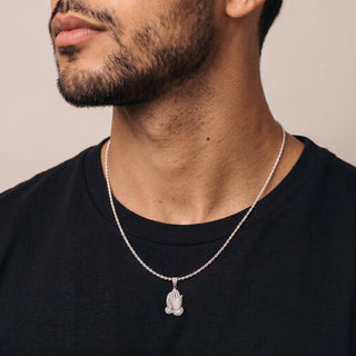 Pavé Praying Hands Moissanite Pendant in sterling silver, worn on model
