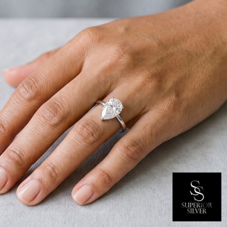 Pear Solitaire on Polished Band Moissanite Ring in sterling silver, worn on hand