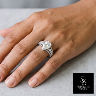 Pear Solitaire with Graduated Side Stones Moissanite Ring in sterling silver, worn on hand