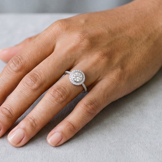 Petite Round Halo on Pavé Band Moissanite Ring in sterling silver, worn on hand