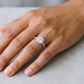 Petite Round Solitaire on Pavé Band Moissanite Ring in sterling silver, worn on hand