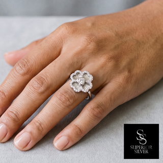 Polished Four-Petal Flower Moissanite Ring in sterling silver, worn on hand