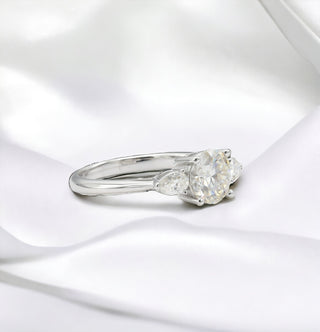 Round and pear three-stone on polished band moissanite ring in sterling silver, view 2