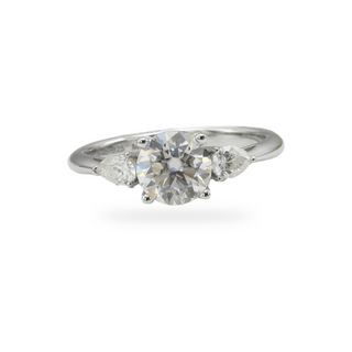 Round and pear three-stone on polished band moissanite ring in sterling silver