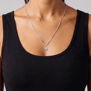 Round Center Cushion Double Halo Moissanite Pendant in sterling silver, worn on model