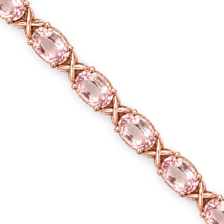 Round cut morganite tennis bracelet in sterling silver, close-up of morganite stones and X links