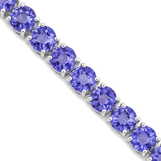 Round cut tanzanite tennis bracelet in sterling silver, close-up of tanzanites in four-prong settings