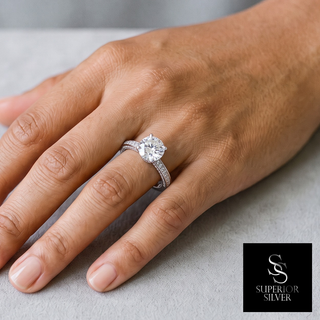 Round Solitaire on Three-Sided Pavé Band Moissanite Ring in sterling silver, worn on hand