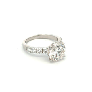 Round solitaire with channel-set round accents moissanite ring in sterling silver