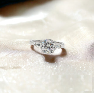 Round solitaire with small prong-set side stones moissanite ring in sterling silver, view 2