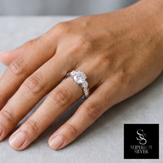 Round Three-Stone on Diamond-Cut Band Moissanite Ring in sterling silver, worn on hand