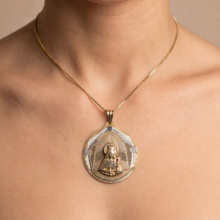 Superior Silver 10K yellow gold Santa Barbara pendant featuring a ruby accent and diamond-cut detailing on a model.