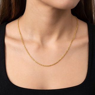 Superior Silver 10K yellow gold Singapore link chain worn on a neck, featuring a 1.7mm twisted design.