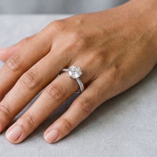 Six-Prong Round Solitaire on Pavé Band Moissanite Ring in sterling silver, worn on hand