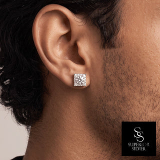 Square halo round solitaire moissanite stud earrings in sterling silver, worn on model
