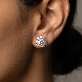 Sterling silver round flower halo moissanite stud earrings shown on model