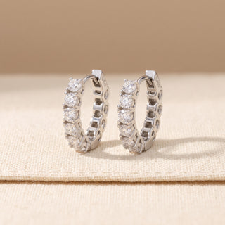 Sterling silver 17mm eternity shared prong moissanite huggie hoop earrings, macro detail