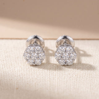 Sterling silver seven stone daisy cluster moissanite stud earrings, macro detail of the shared prong setting