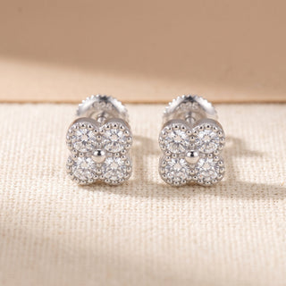Sterling silver beaded quatrefoil moissanite stud earrings, macro detail of the milgrain borders