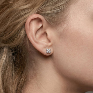 Sterling silver beaded quatrefoil moissanite stud earrings shown on model