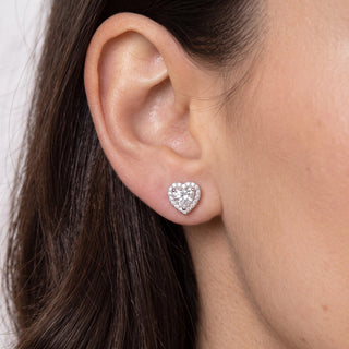 Sterling silver heart shaped halo moissanite stud earrings shown on model