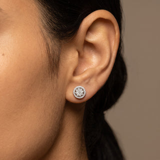 Model wearing sterling silver flower cluster double halo moissanite stud earrings