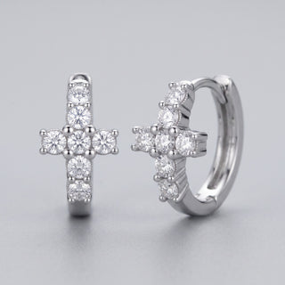 Close-up of the sterling silver cross huggie showing the milgrain edges and hinged snap closure