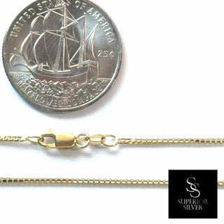 Superior Silver 10K yellow gold 1.0mm diamond-cut box link chain with a lobster clasp shown next to a US quarter.