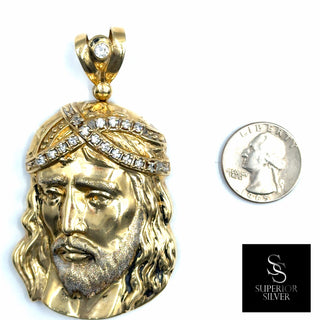 Superior Silver 10K yellow gold Jesus pendant featuring a CZ-encrusted crown of thorns, shown next to a US quarter.