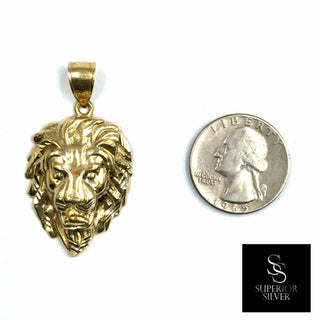 Superior Silver 10K yellow gold lion head pendant with diamond-cut detailing shown next to a US quarter for scale.