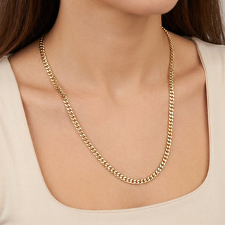 Superior Silver 18-inch 3.5mm Miami Cuban link chain in solid 10K yellow gold worn around a woman's neck