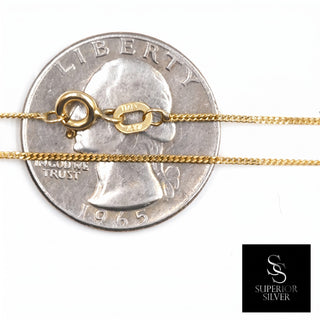 Superior Silver 10K yellow gold 1.0mm micro curb link chain with spring ring clasp shown against a US quarter coin.