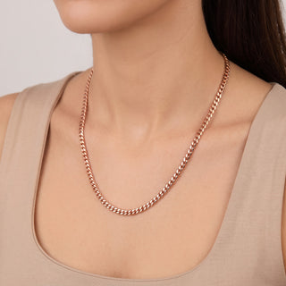 Superior Silver 16-inch 3.9mm solid 10K rose gold Miami Cuban link chain worn around a woman's neck