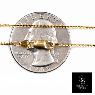 Superior Silver 10K yellow gold 1.0mm box link chain with a secure lobster clasp shown against a US quarter coin.