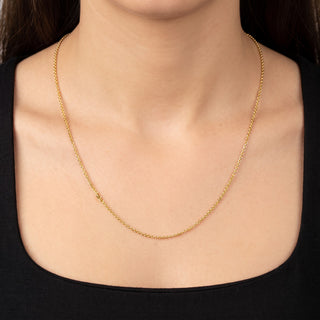Superior Silver 22-inch delicate 10K yellow gold cable link chain worn around a woman's neck