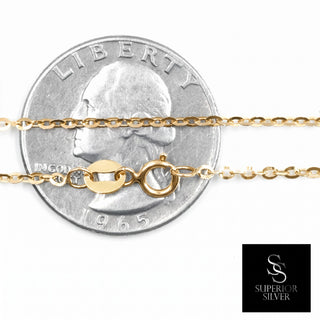Superior Silver 18-inch 10K yellow gold flat cable link chain with a spring ring clasp shown against a US quarter.