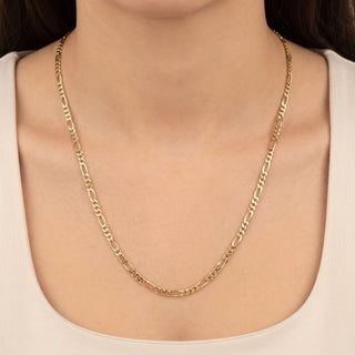 Superior Silver 10K yellow gold 3.2mm Figaro link chain worn around a model's neck, featuring a polished finish.