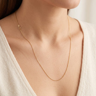 Superior Silver 20-inch solid 10K yellow gold link chain necklace worn on a model with a white top