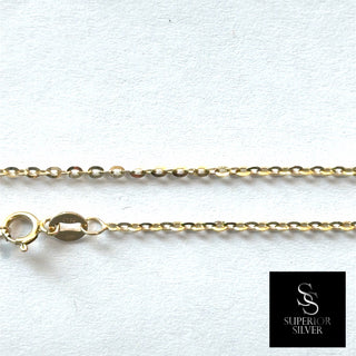 Superior Silver 10K yellow gold 1.6mm flat cable link chain with a spring ring clasp on a white background